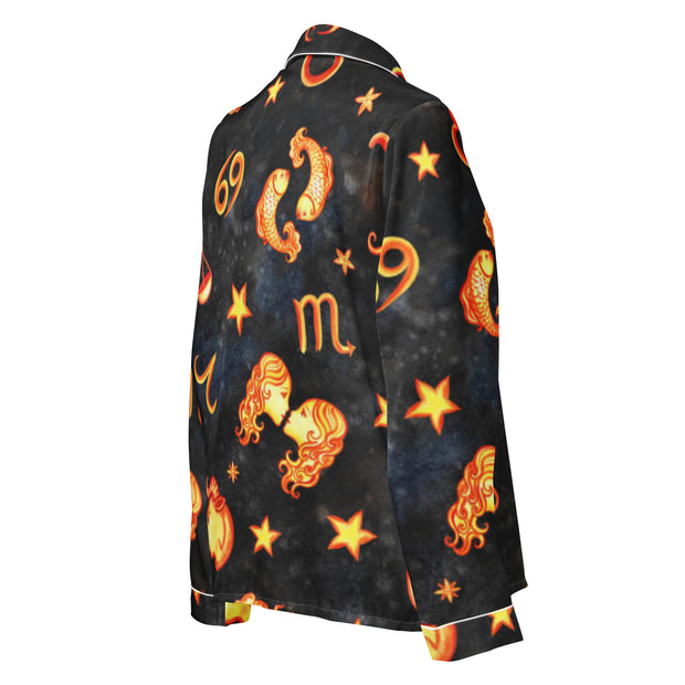 Black shirt with orange zodiac symbols and designs on a white background