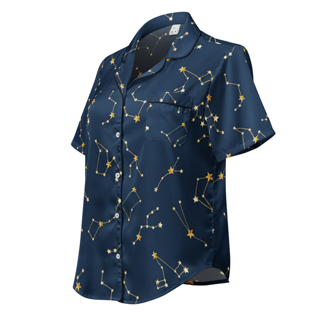 Navy blue shirt with gold constellation pattern on a white background