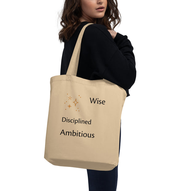 Beige tote bag with motivational text held by a person on a white background