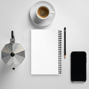 Coffee maker, coffee cup, notebook, pencil, and smartphone on a light gray surface