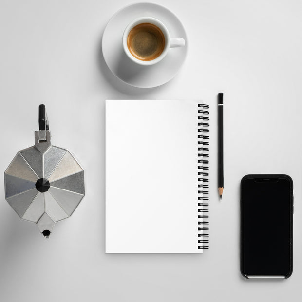 Coffee maker, coffee cup, notebook, pencil, and smartphone on a light gray surface