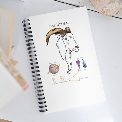 Notebook with Capricorn design on a white surface