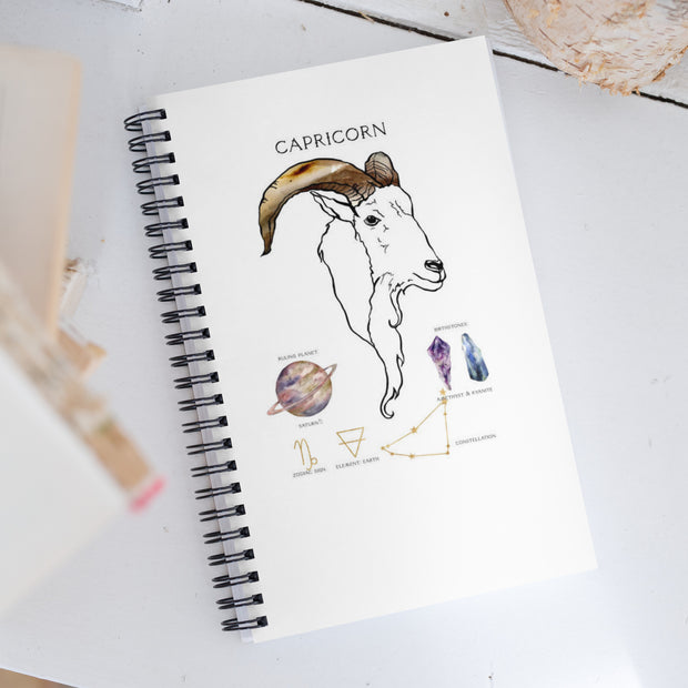 Notebook with Capricorn design on a white surface