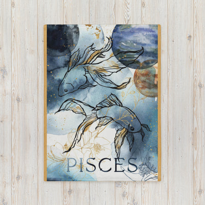 Framed artwork of Pisces zodiac sign with stylized fish on a wooden surface